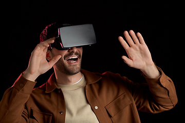 Image showing happy man in vr glasses over black background