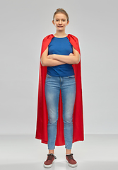 Image showing smiling teenage girl in red superhero cape