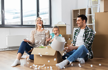 Image showing happy family playing with foam peanuts at new home