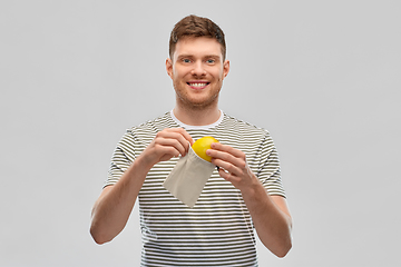 Image showing smiling man with lemon in reusable canvas bag