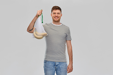 Image showing happy man holding reusable string bag with bananas