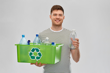 Image showing smiling young man sorting plastic waste