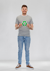 Image showing smiling young man holding green recycling sign