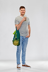 Image showing man with bag for food shopping and green smoothie