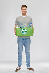 Image showing smiling young man sorting plastic waste