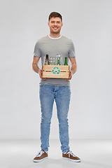 Image showing smiling young man sorting glass waste