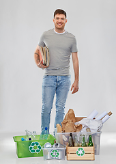 Image showing smiling man sorting paper, metal and plastic waste