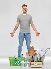 Image showing smiling man sorting paper, metal and plastic waste