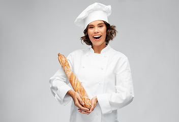 Image showing happy female chef with french bread or baguette