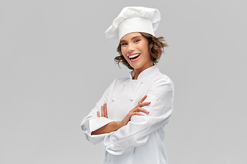 Image showing smiling female chef in toque with crossed arms