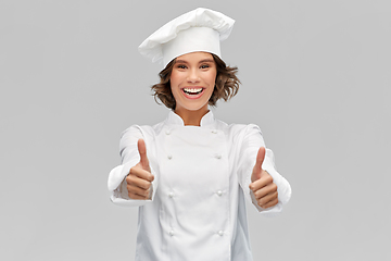 Image showing smiling female chef in toque showing thumbs up