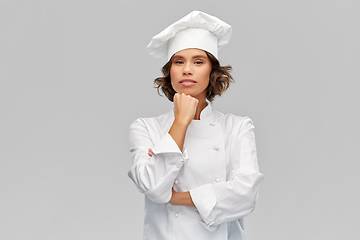 Image showing female chef in toque thinking