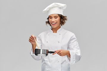 Image showing happy smiling female chef with saucepan