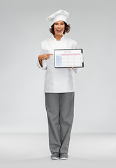 Image showing smiling female chef holding with diet plan