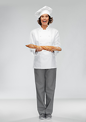 Image showing happy female chef with french bread or baguette