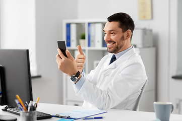 Image showing doctor with smartphone having video call at clinic