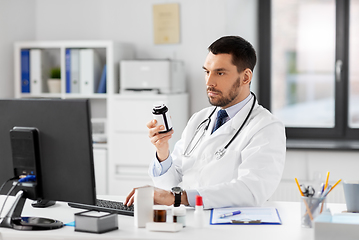 Image showing male doctor with medicine and computer at hospital