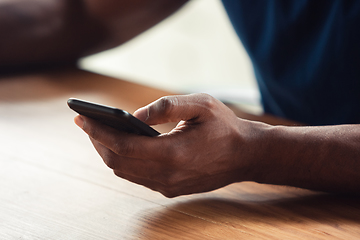 Image showing Close up of african-american male hands, working in office