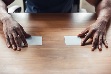 Image showing Close up of african-american male hands, working in office