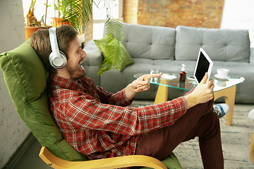 Image showing Caucasian man staying at home during quarantine because of coronavirus spreading