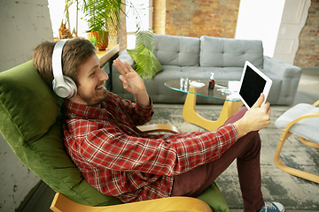 Image showing Caucasian man staying at home during quarantine because of coronavirus spreading