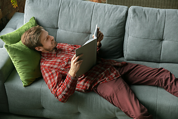 Image showing Caucasian man staying at home during quarantine because of coronavirus spreading