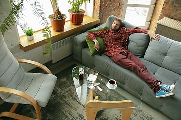 Image showing Caucasian man staying at home during quarantine because of coronavirus spreading