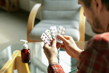 Image showing Caucasian man staying at home during quarantine because of coronavirus spreading