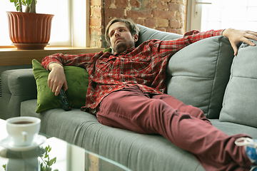 Image showing Caucasian man staying at home during quarantine because of coronavirus spreading