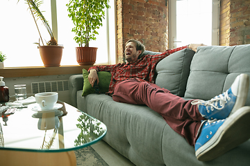 Image showing Caucasian man staying at home during quarantine because of coronavirus spreading