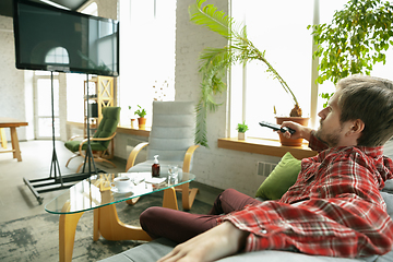 Image showing Caucasian man staying at home during quarantine because of coronavirus spreading