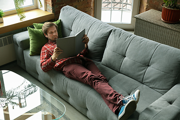 Image showing Caucasian man staying at home during quarantine because of coronavirus spreading