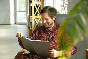 Image showing Caucasian man staying at home during quarantine because of coronavirus spreading