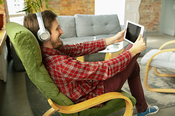 Image showing Caucasian man staying at home during quarantine because of coronavirus spreading