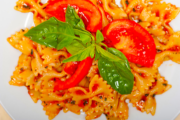 Image showing Italian pasta farfalle butterfly bow-tie and tomato sauce