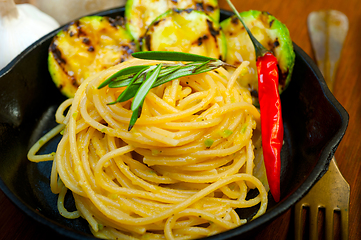 Image showing italian spaghetti pasta with zucchini sauce on iron skillet