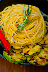 Image showing italian spaghetti pasta with zucchini sauce on iron skillet