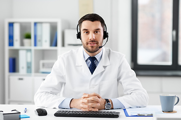 Image showing happy male doctor with headset at hospital