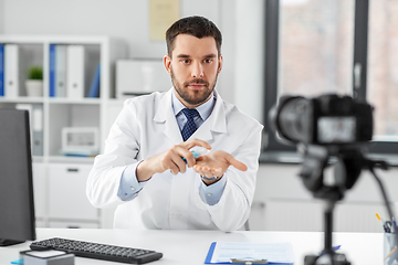 Image showing doctor with hand sanitizer recording video blog