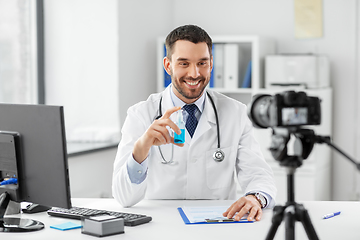 Image showing doctor with hand sanitizer recording video blog