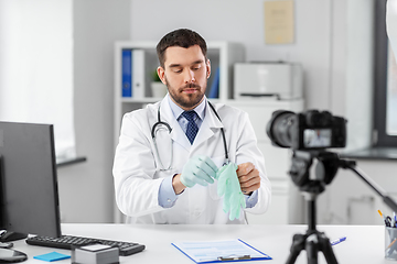 Image showing male doctor with gloves recording video blog