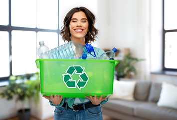 Image showing smiling young woman sorting plastic waste