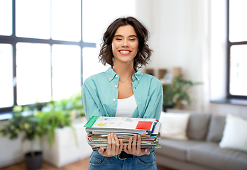 Image showing smiling young woman sorting paper waste