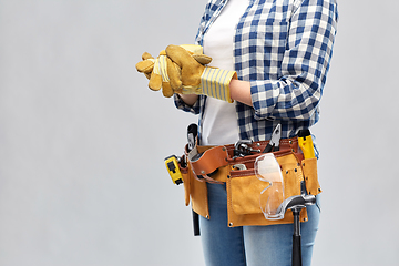 Image showing woman or builder with gloves and working tools