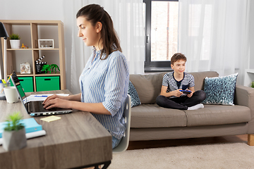 Image showing boy with gamepad playing video game at home