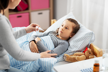 Image showing mother measuring temperature of sick daughter