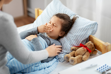 Image showing mother and sick little daughter in bed at home