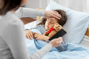 Image showing sick daughter and mother with phone at home