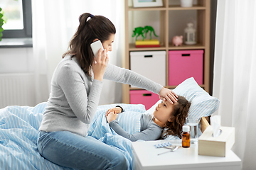 Image showing ill daughter and mother calling on phone at home