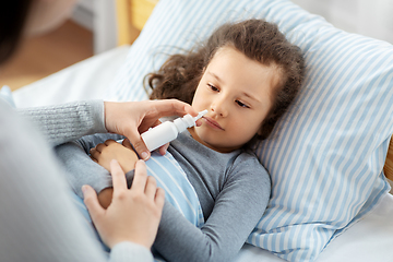 Image showing mother with nasal spray treats sick daughter